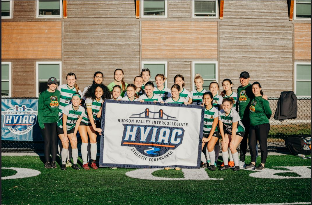 Womens soccer with banner 