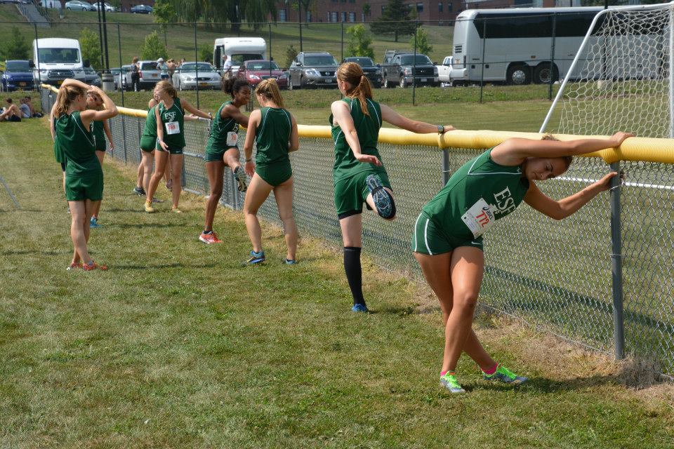 The Mighty Oaks women's cross country team stretches before its race at LeMoyne College (photo courtesy of Bob Beary)